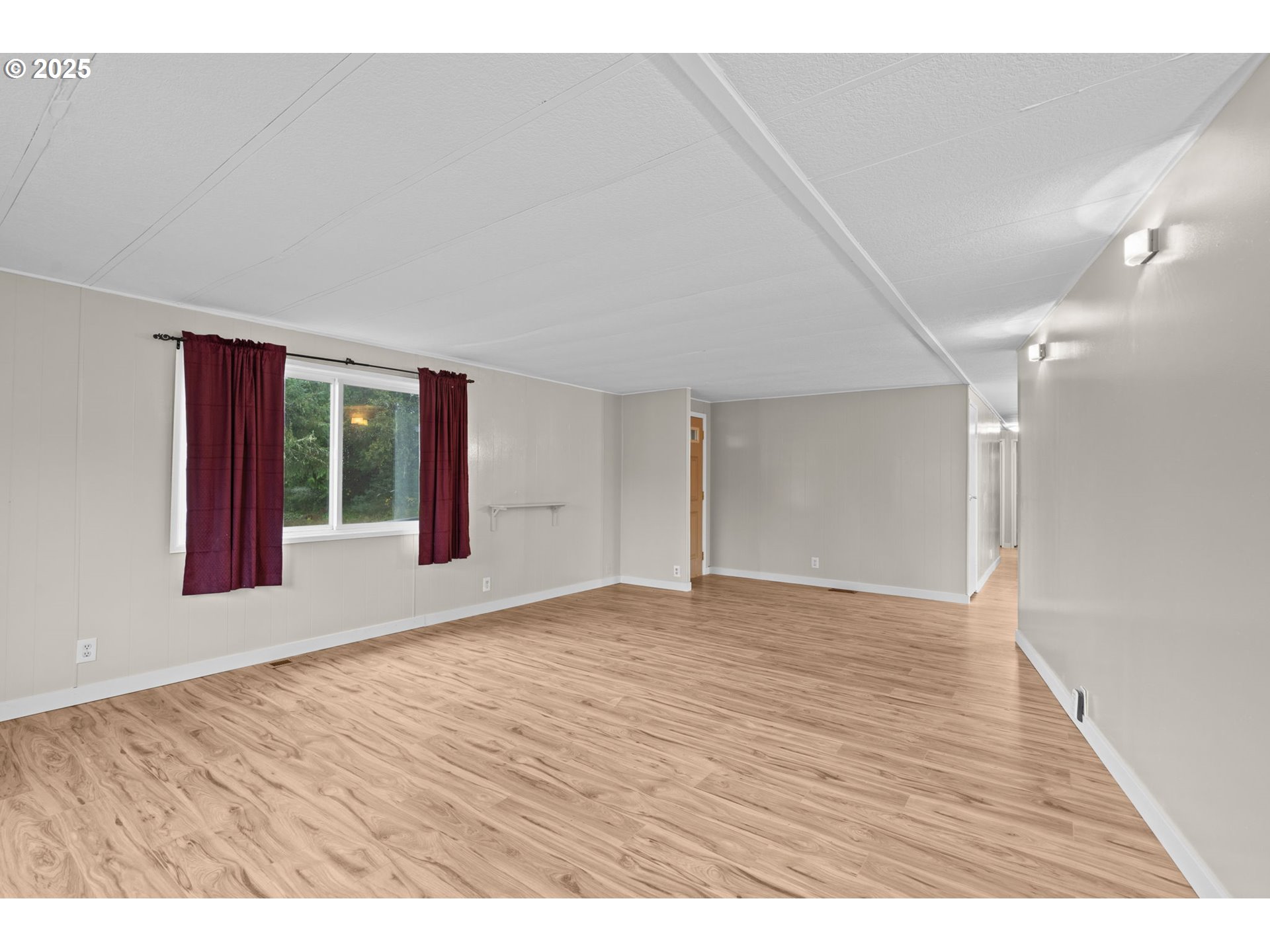 2657 North Highway 101, Unit 6 Seaside, OR 97138 - Photo 2 of 13 a view of an empty room with window and wooden floor