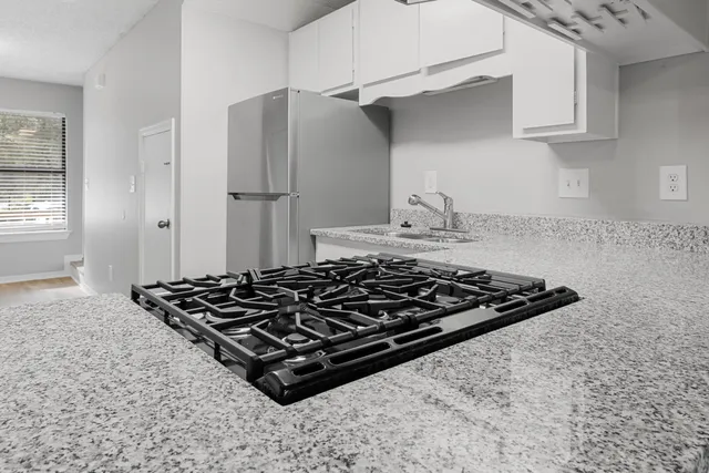a stove top oven sitting inside of a kitchen