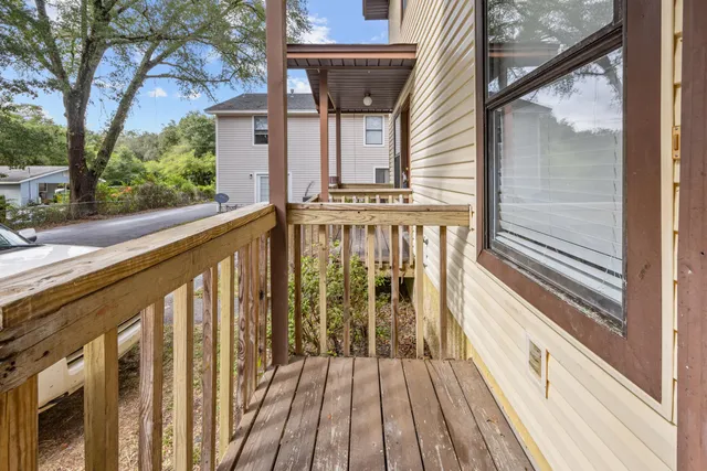 a view of balcony with wooden floor and fence