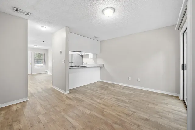 a view of a kitchen with a sink and a refrigerator