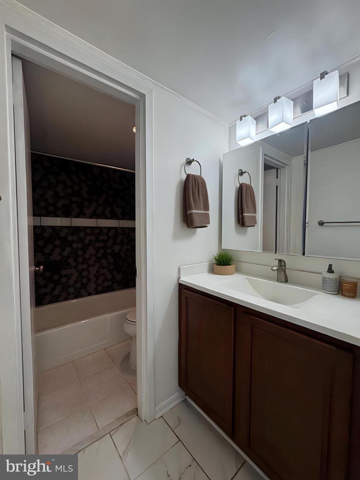 2059 Huntington Avenue, Unit 1101 Alexandria, VA 22303 - Photo 11 of 35 a bathroom with a double vanity sink and mirror