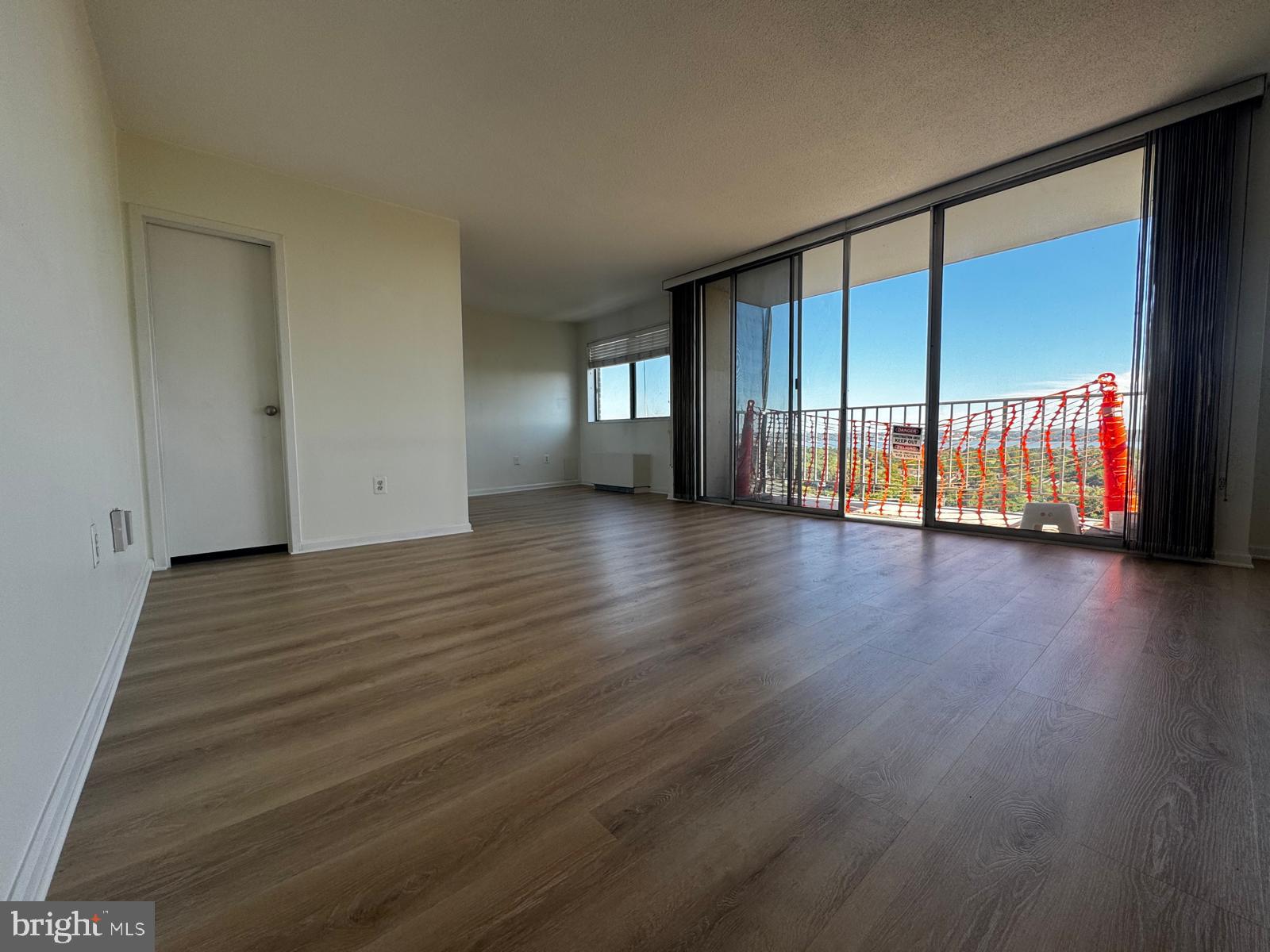 2059 Huntington Avenue, Unit 1101 Alexandria, VA 22303 - Photo 14 of 35 a view of an empty room with wooden floor and a window