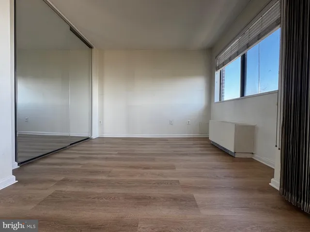 a view of an empty room and wooden floor