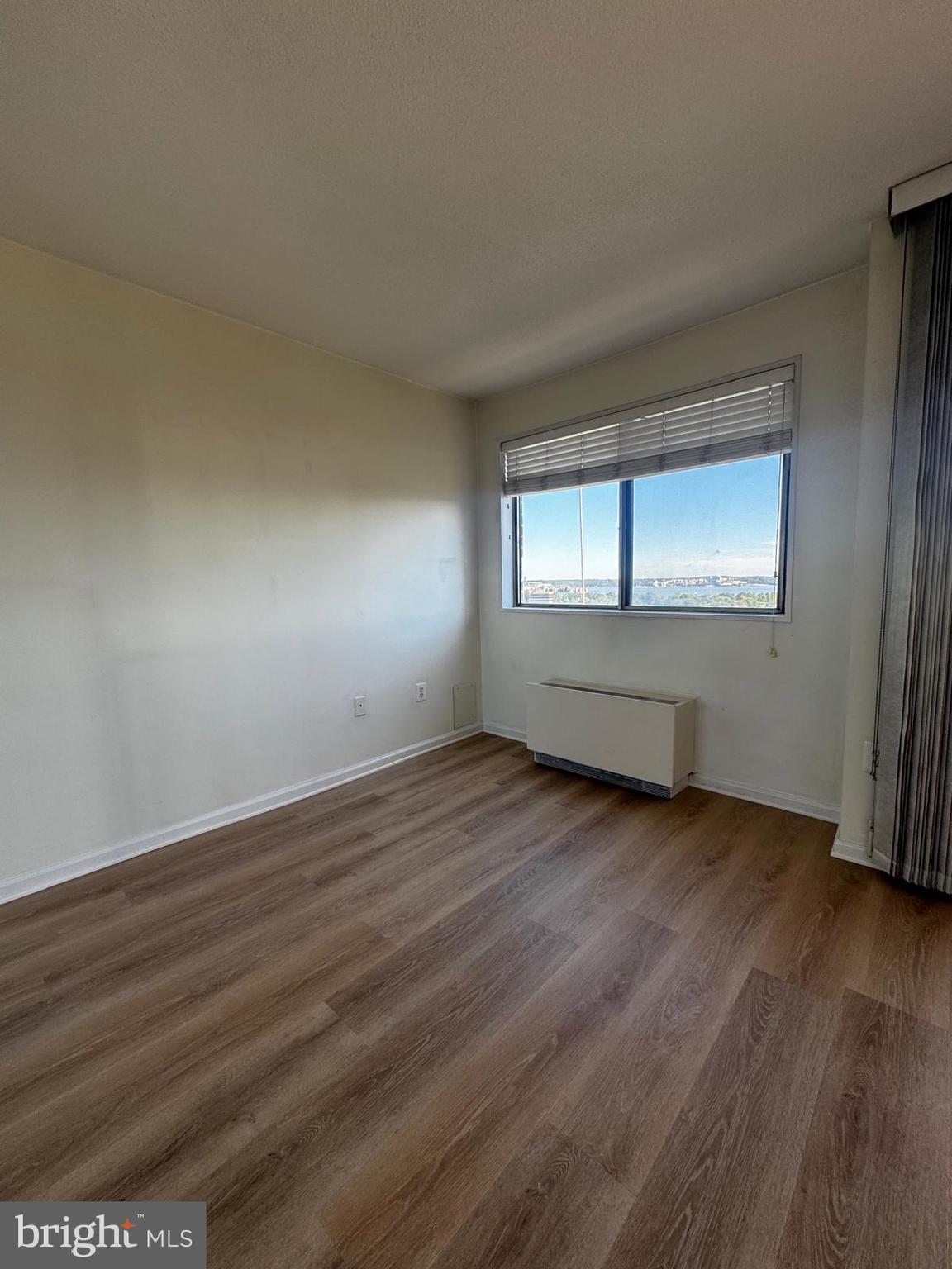 2059 Huntington Avenue, Unit 1101 Alexandria, VA 22303 - Photo 18 of 35 an empty room with wooden floor and windows
