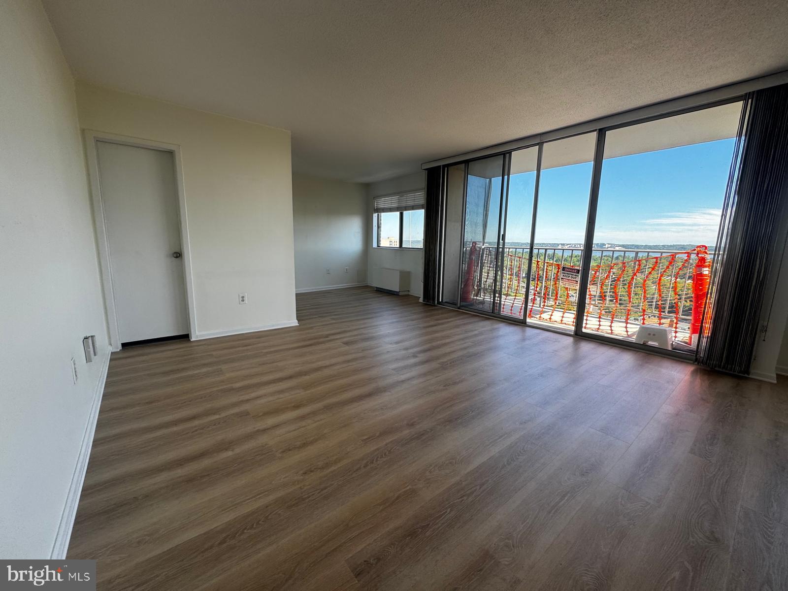2059 Huntington Avenue, Unit 1101 Alexandria, VA 22303 - Photo 19 of 35 a view of an empty room with wooden floor and a window