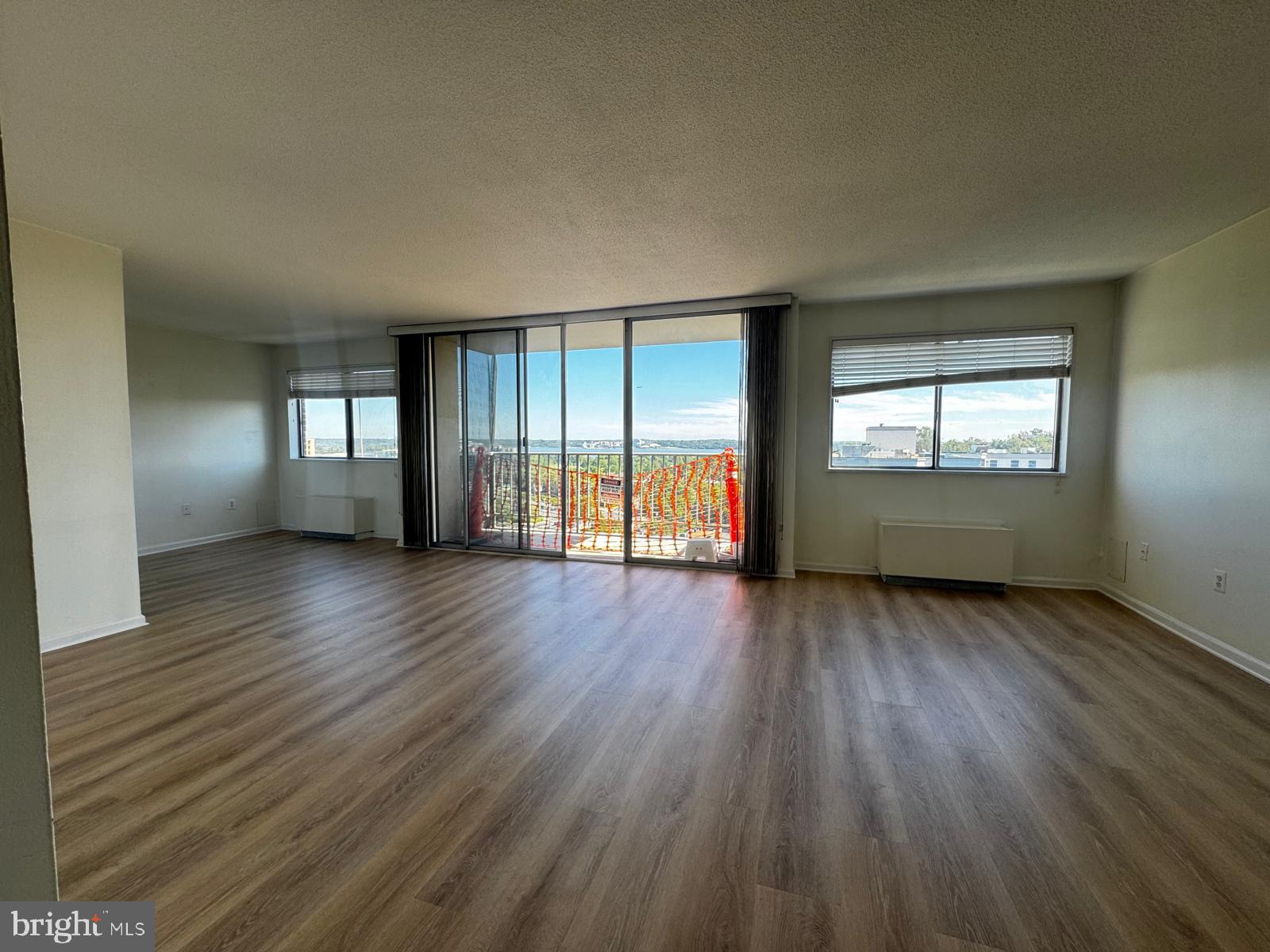 2059 Huntington Avenue, Unit 1101 Alexandria, VA 22303 - Photo 20 of 35 an empty room with wooden floor and windows