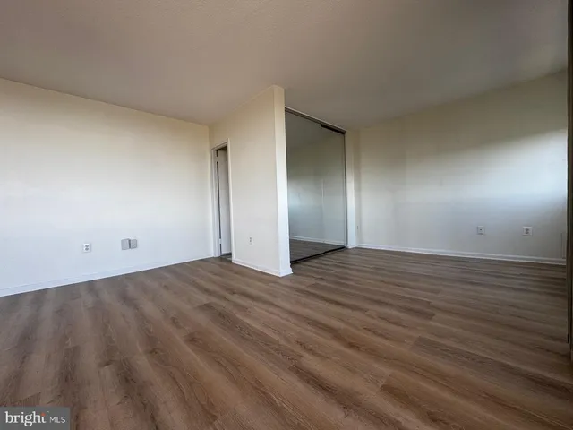a view of an empty room and wooden floor