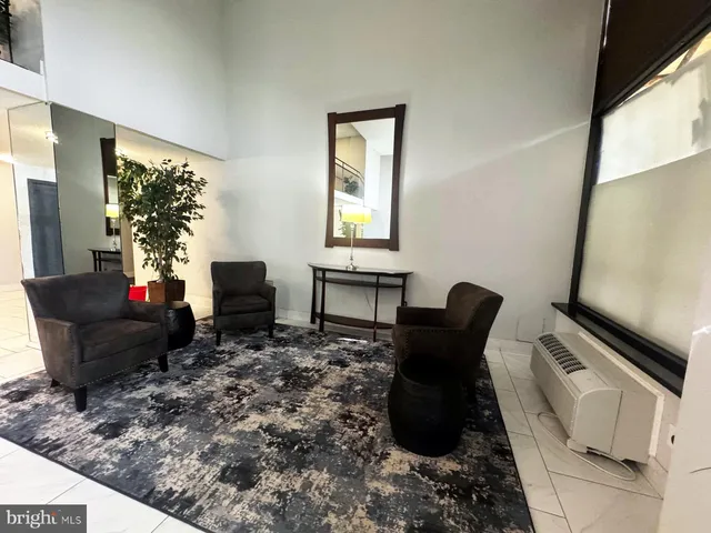 a living room with furniture rug and a flat screen tv