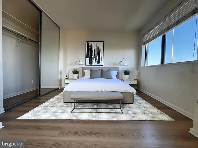 a bedroom with a bed and wooden floor