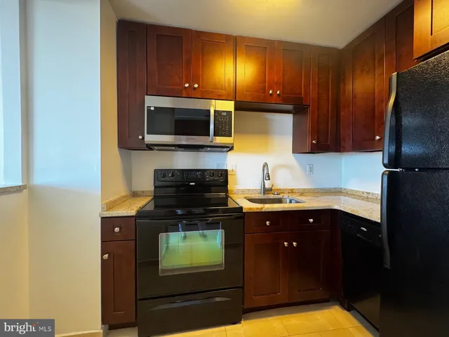 a kitchen with a sink and a refrigerator