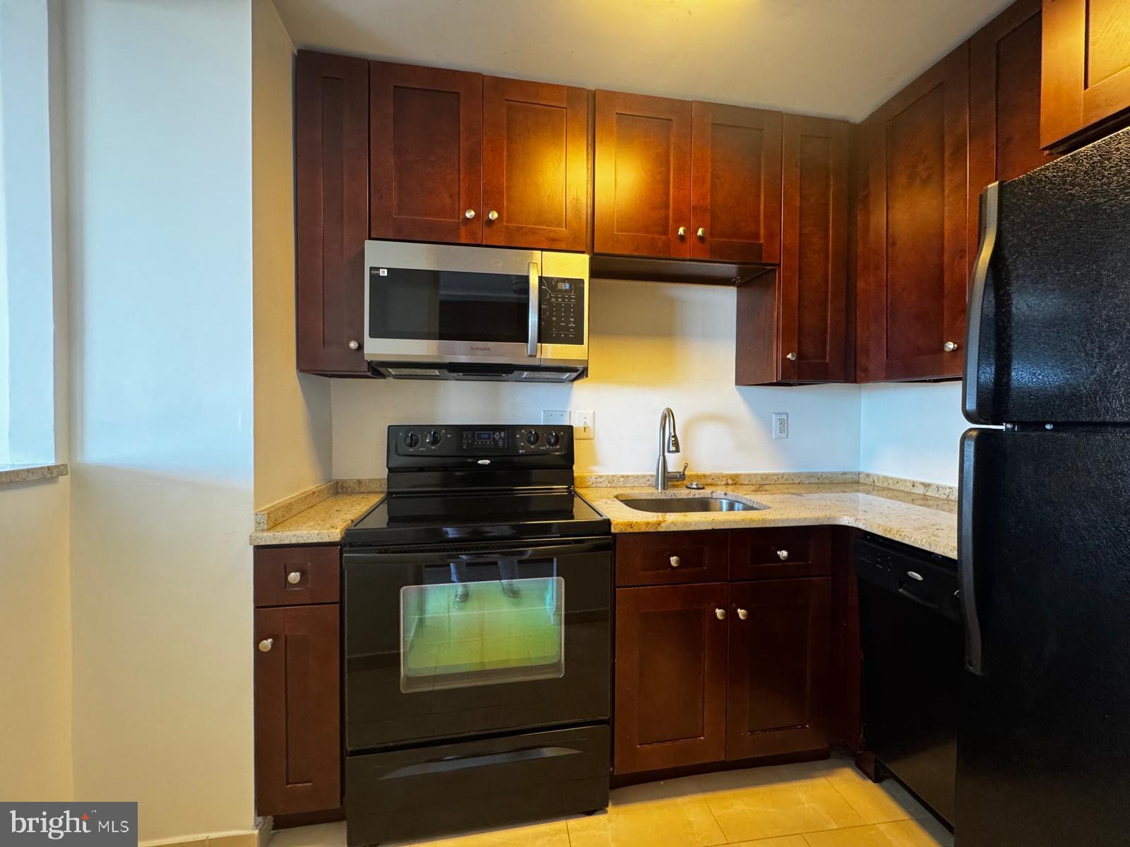 2059 Huntington Avenue, Unit 1101 Alexandria, VA 22303 - Photo 5 of 35 a kitchen with a sink and a refrigerator