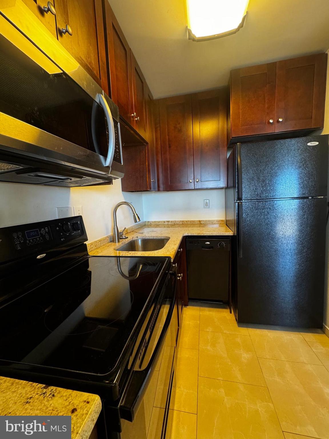 2059 Huntington Avenue, Unit 1101 Alexandria, VA 22303 - Photo 10 of 35 a kitchen with a sink and cabinets