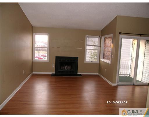 236 Edpas Road New Brunswick, NJ 08901 - Photo 4 of 15 a view of an empty room with wooden floor and a window