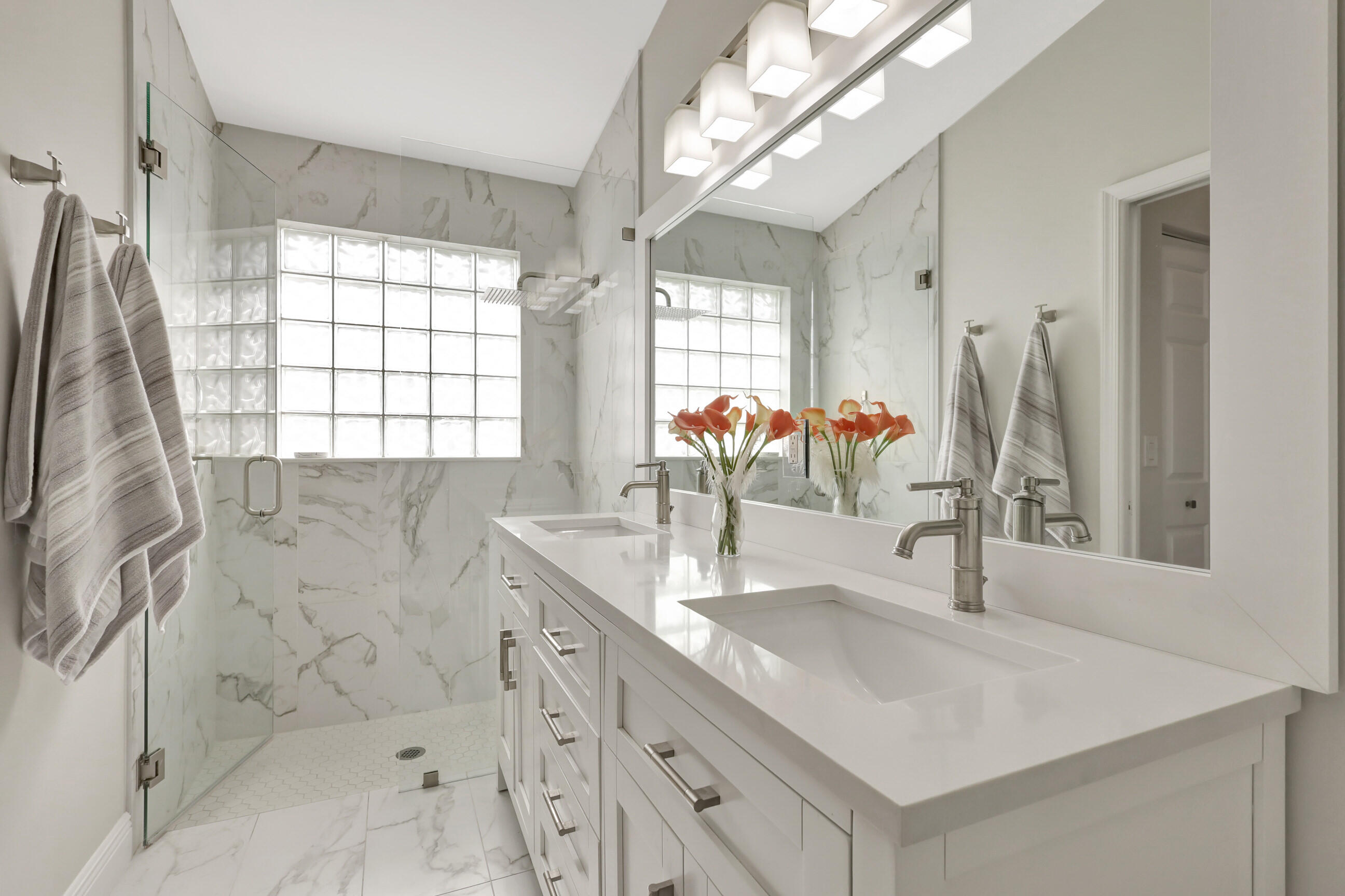 12204 Sunset Point Circle Wellington, FL 33414 - Photo 20 of 40 a bathroom with double vanity sink a mirror and a shower