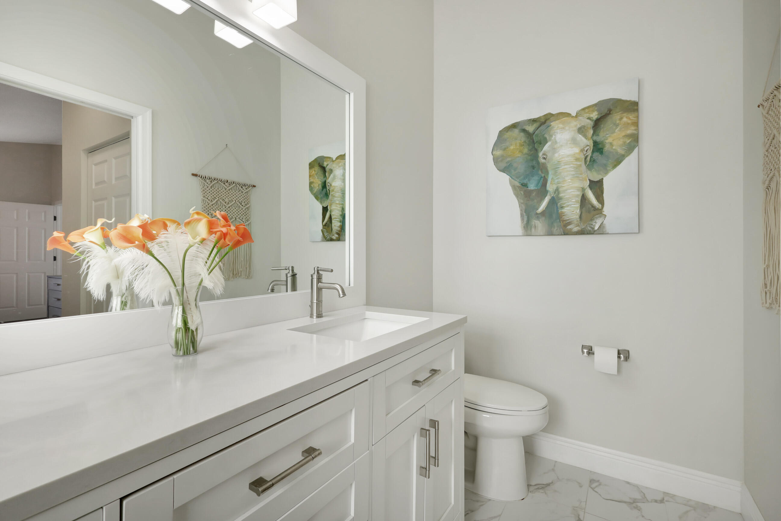 12204 Sunset Point Circle Wellington, FL 33414 - Photo 21 of 40 a bathroom with a sink a toilet and mirror
