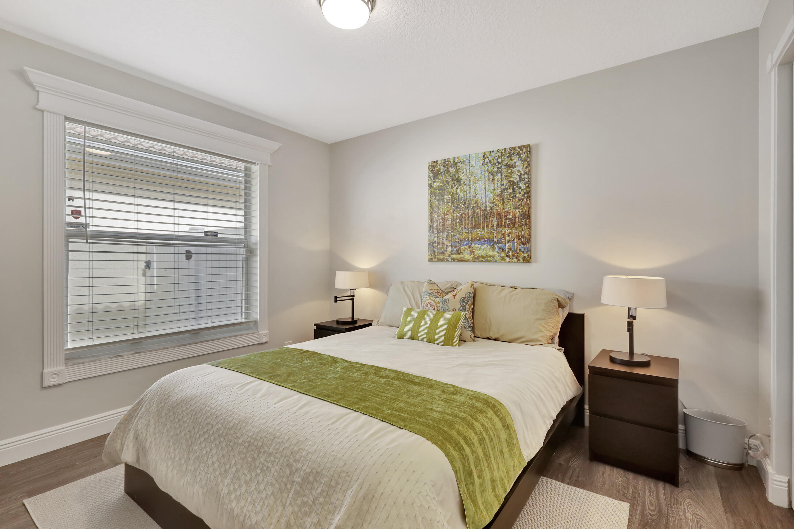 12204 Sunset Point Circle Wellington, FL 33414 - Photo 25 of 40 a bedroom with a bed and a night stand