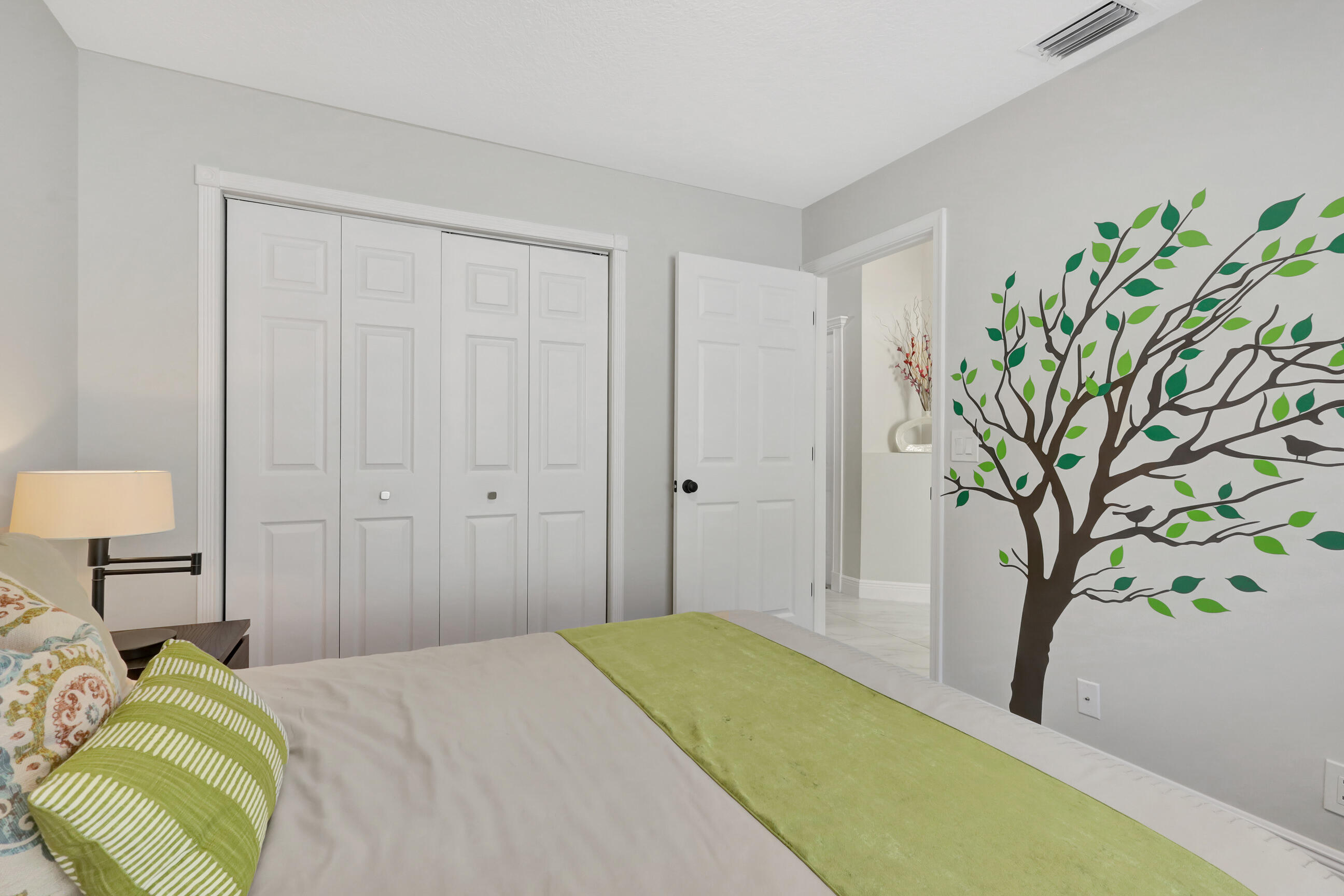 12204 Sunset Point Circle Wellington, FL 33414 - Photo 26 of 40 a bedroom with a bed and a plant