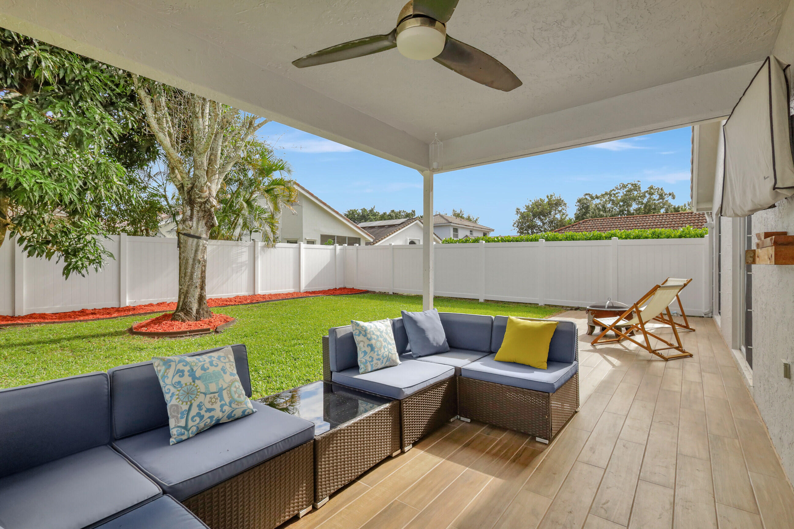 12204 Sunset Point Circle Wellington, FL 33414 - Photo 28 of 40 a couch sitting in a yard with swimming pool view