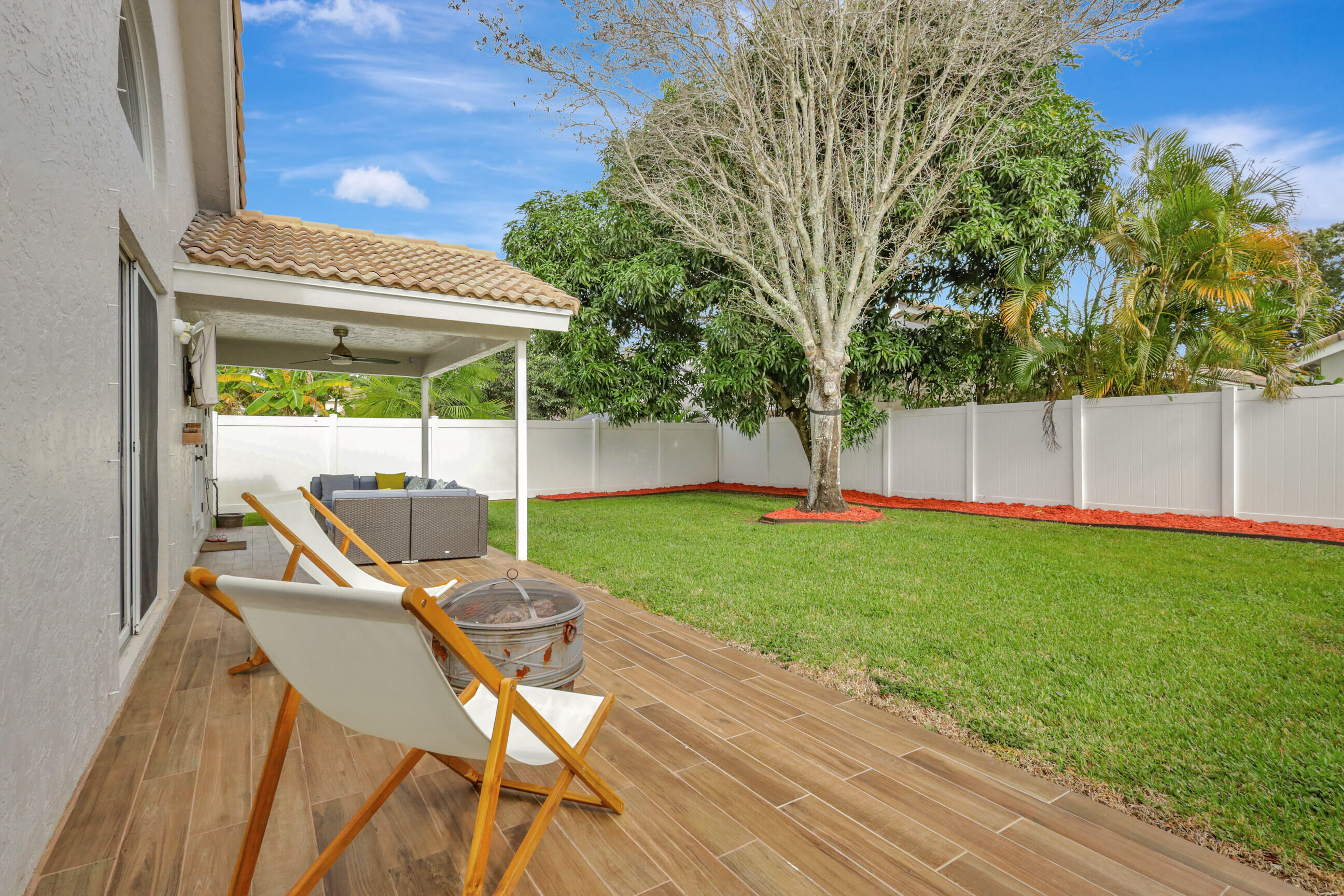 12204 Sunset Point Circle Wellington, FL 33414 - Photo 29 of 40 a backyard view of a house with a patio