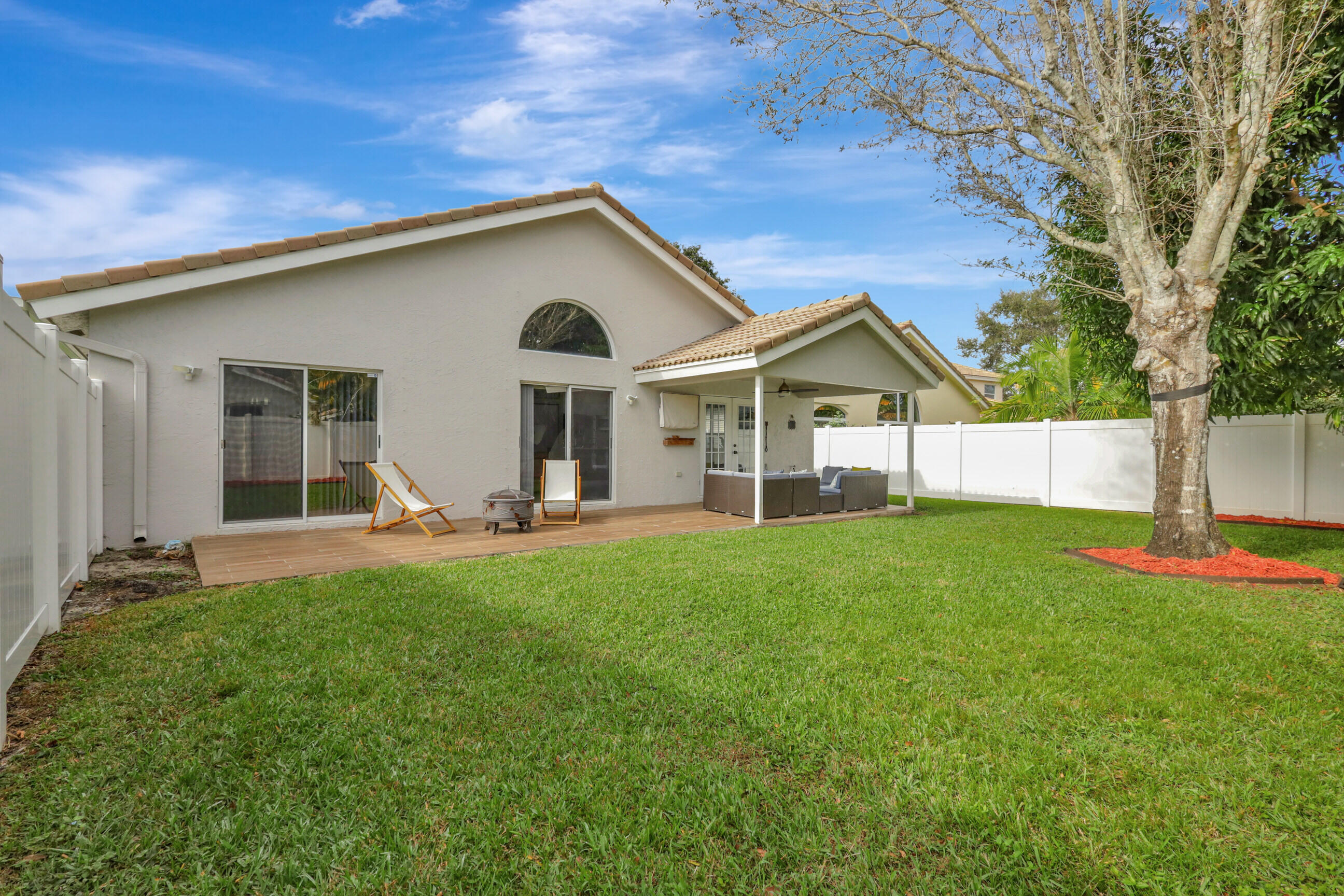 12204 Sunset Point Circle Wellington, FL 33414 - Photo 30 of 40 a view of a house with backyard and a tree