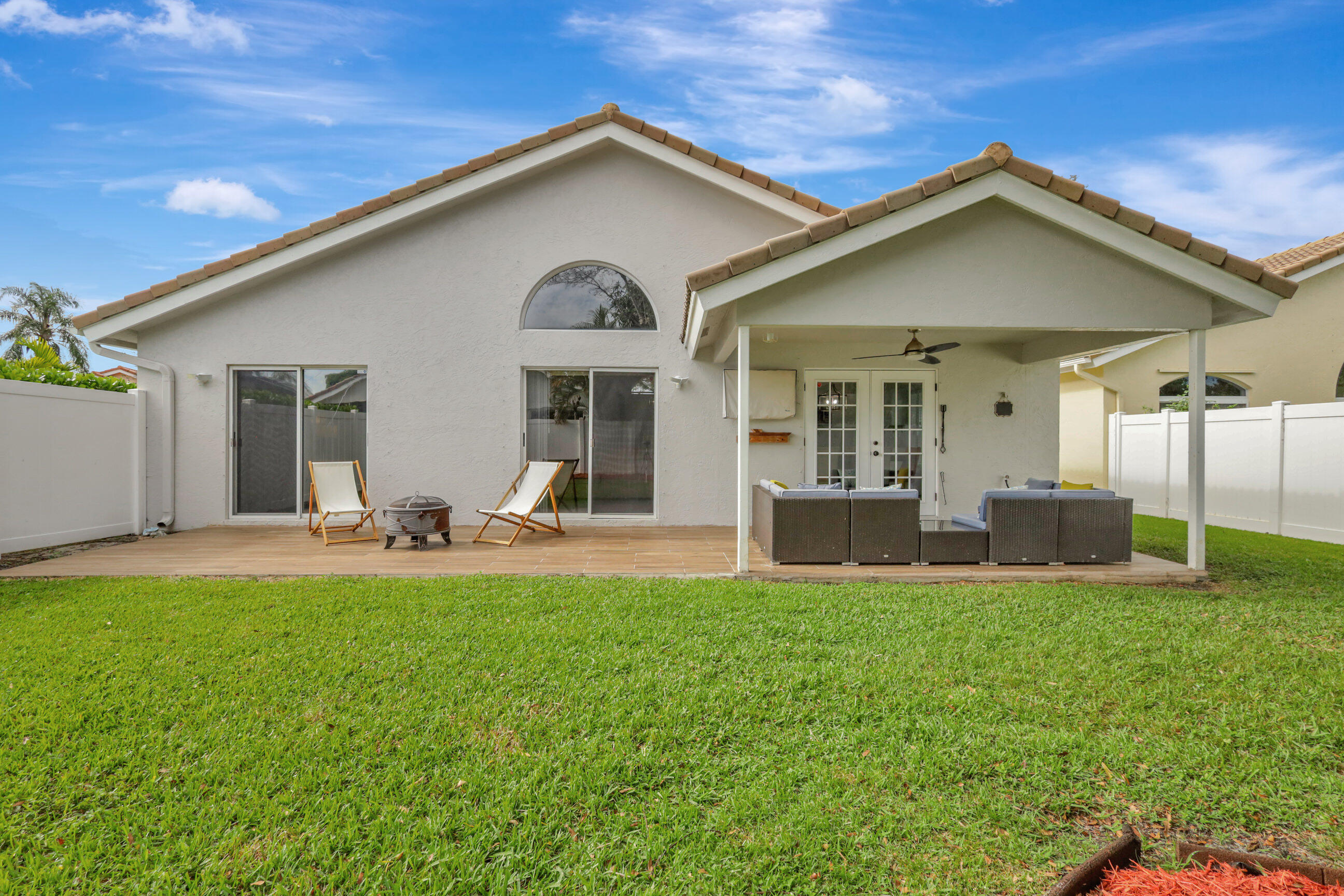 12204 Sunset Point Circle Wellington, FL 33414 - Photo 31 of 40 a view of a house with a yard and sitting area