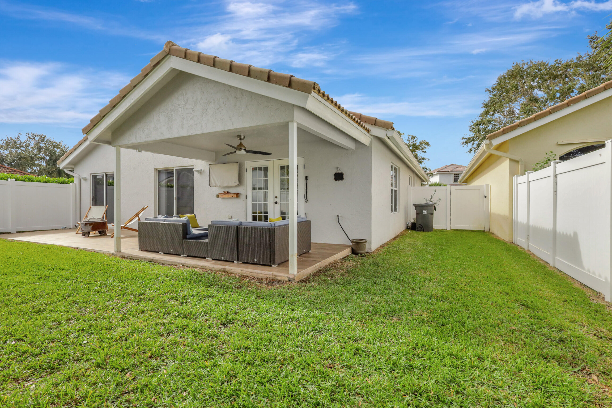 12204 Sunset Point Circle Wellington, FL 33414 - Photo 32 of 40 a view of a house with backyard and sitting area