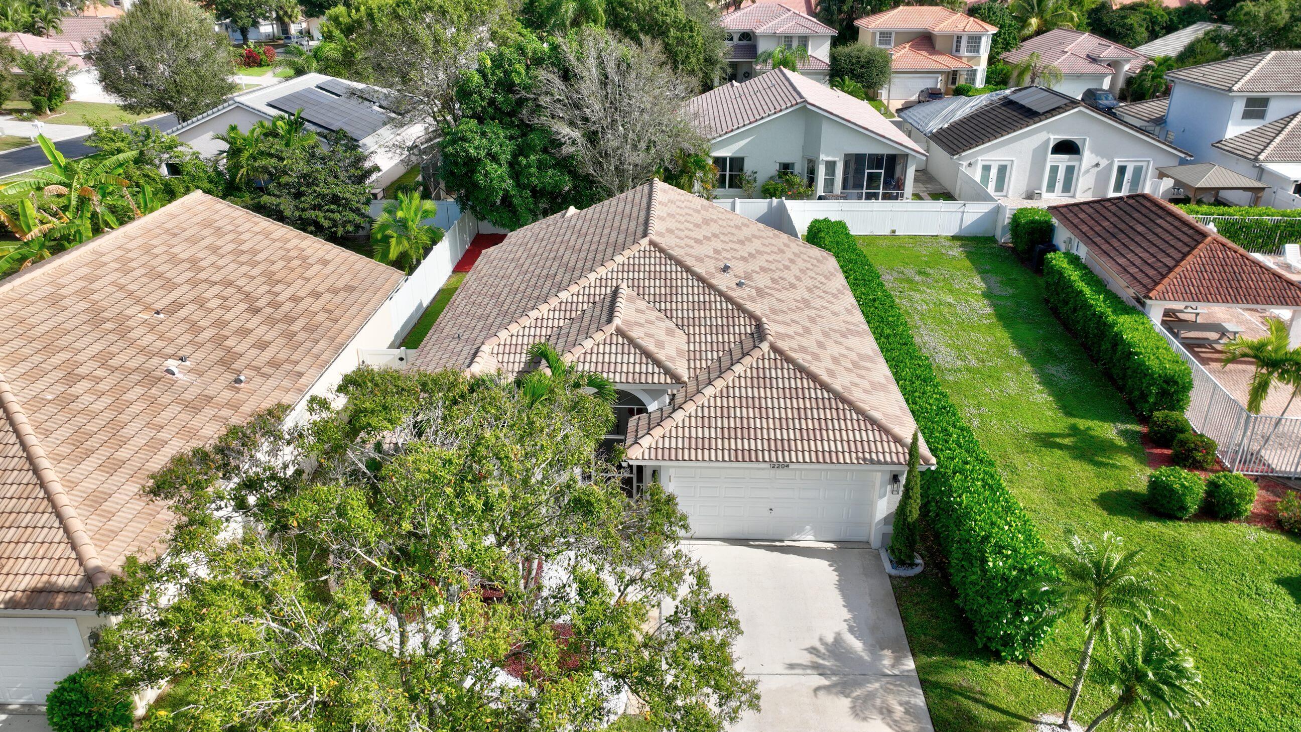 12204 Sunset Point Circle Wellington, FL 33414 - Photo 35 of 40 a aerial view of a house with a yard and potted plants