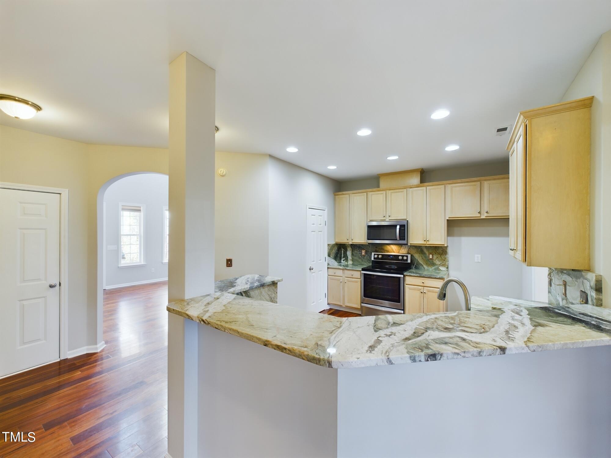 11124 Slider Drive Raleigh, NC 27614 - Photo 15 of 62 a kitchen with stainless steel appliances kitchen island granite countertop a sink and cabinets