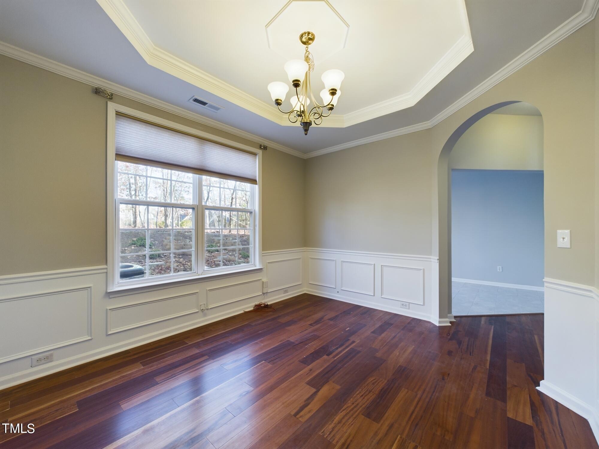 11124 Slider Drive Raleigh, NC 27614 - Photo 16 of 62 a view of an empty room with wooden floor and a window