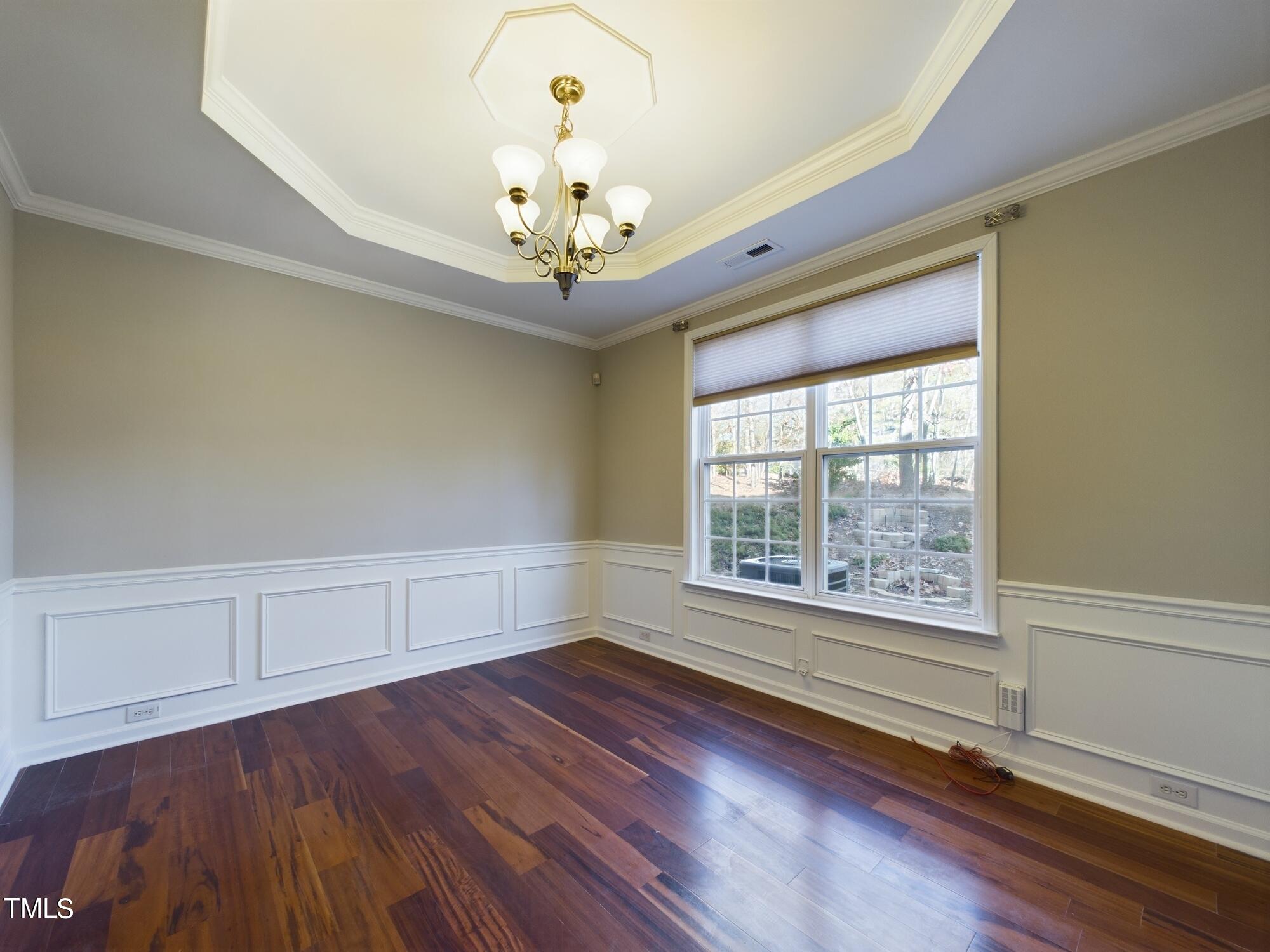 11124 Slider Drive Raleigh, NC 27614 - Photo 19 of 62 a view of an empty room with wooden floor and a window