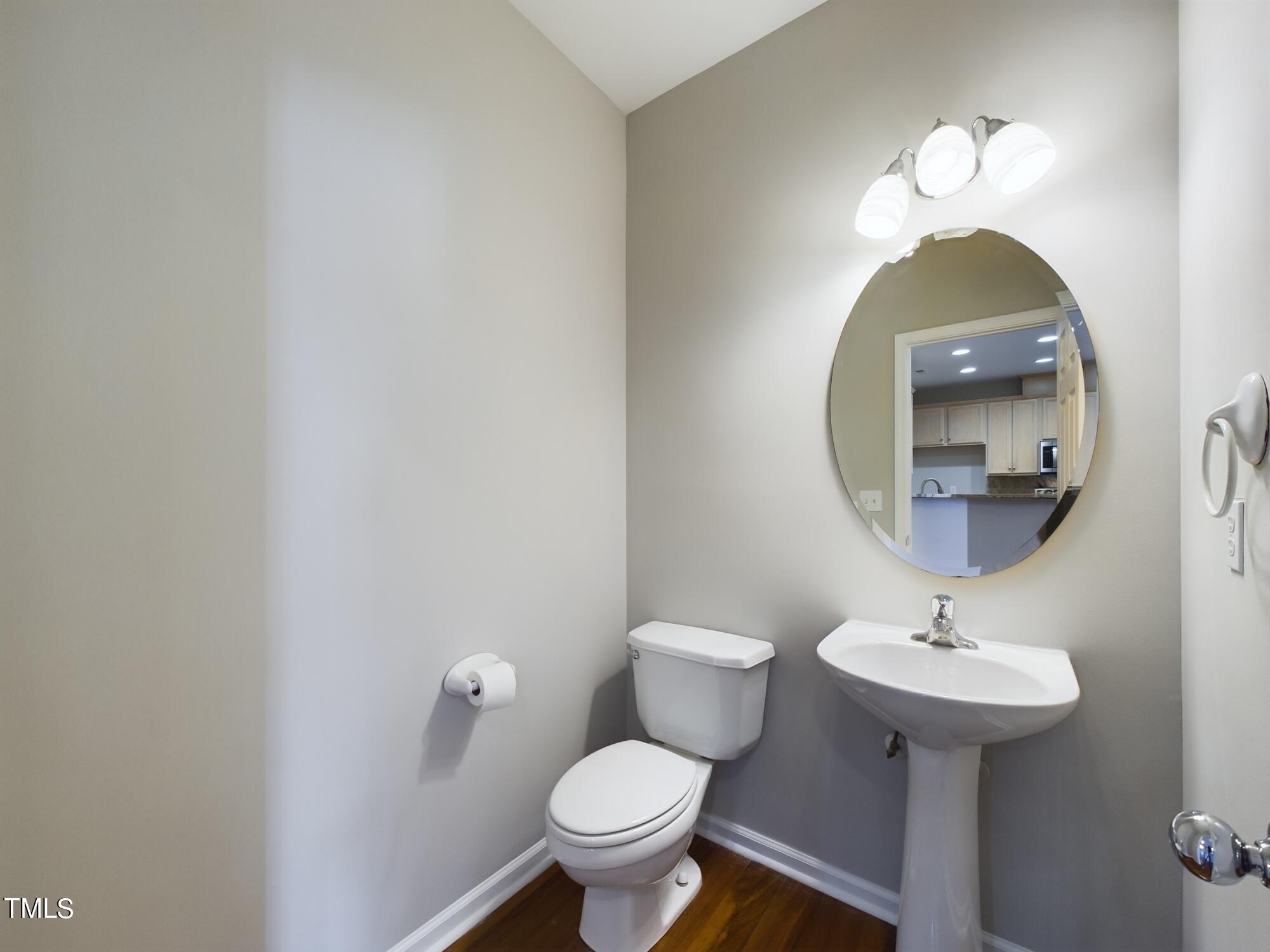 11124 Slider Drive Raleigh, NC 27614 - Photo 24 of 62 a bathroom with a toilet a sink and a mirror