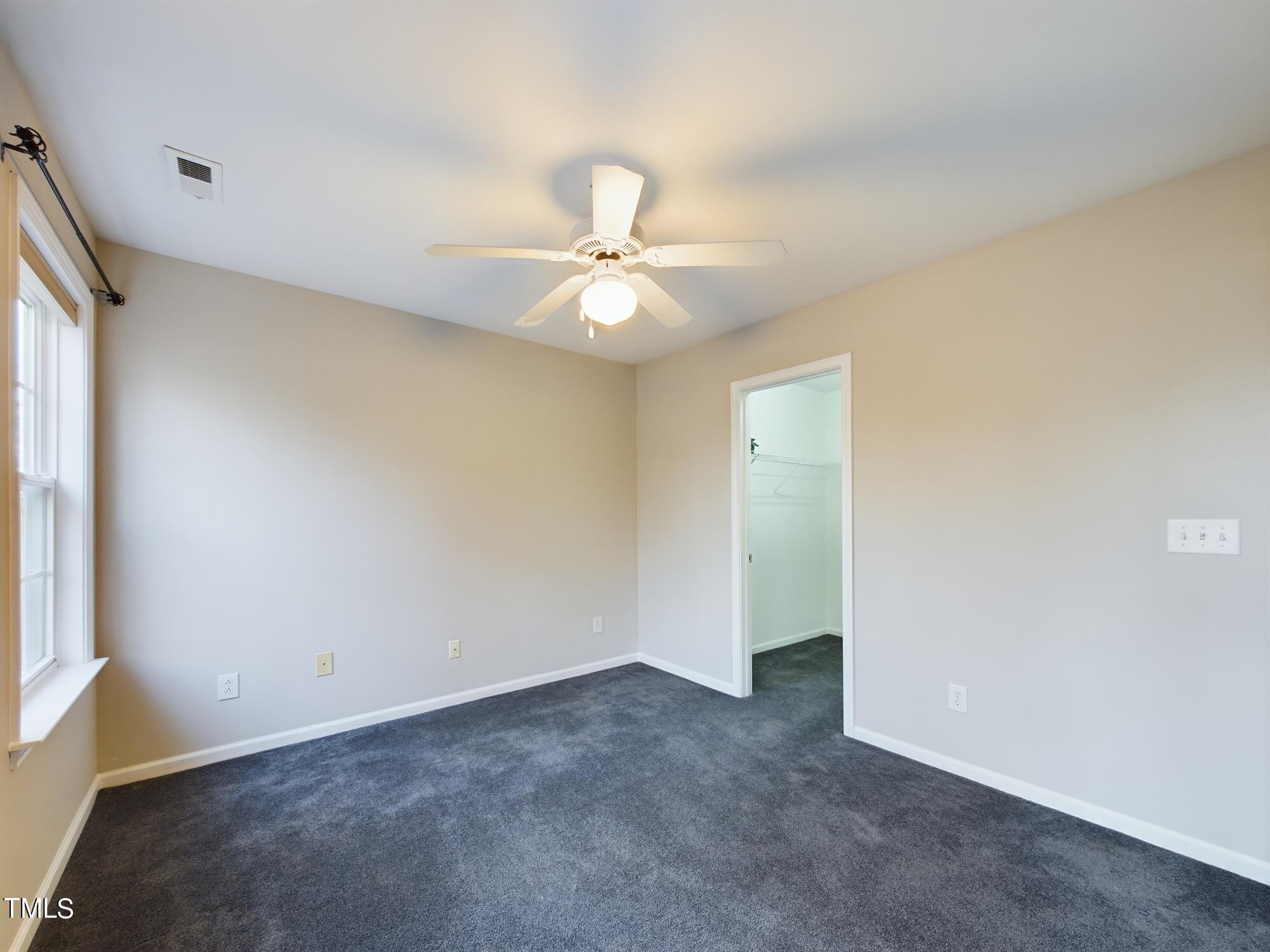 11124 Slider Drive Raleigh, NC 27614 - Photo 30 of 62 an empty room with a window and a ceiling fan