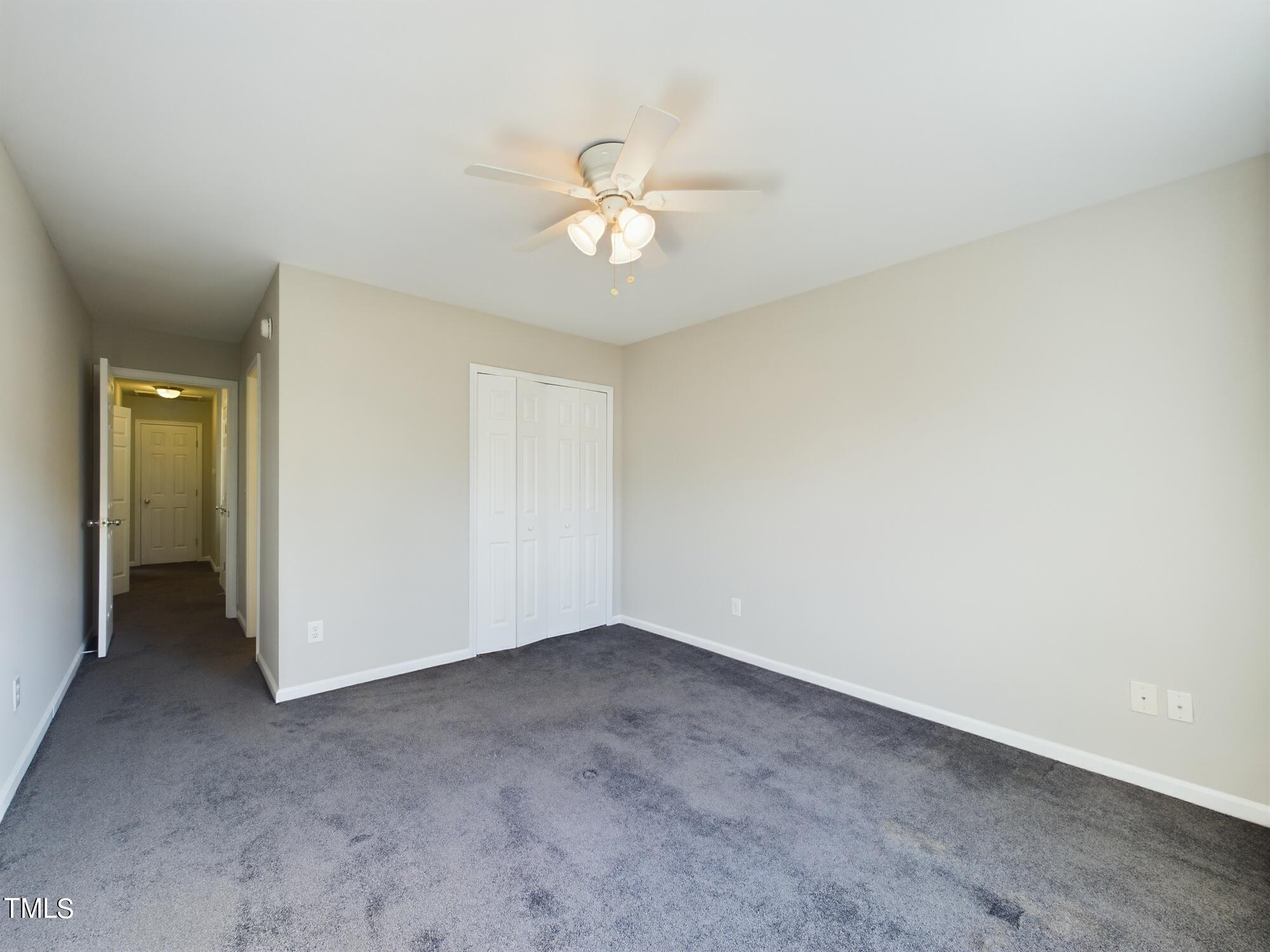 11124 Slider Drive Raleigh, NC 27614 - Photo 41 of 62 an empty room with closet and a chandelier fan