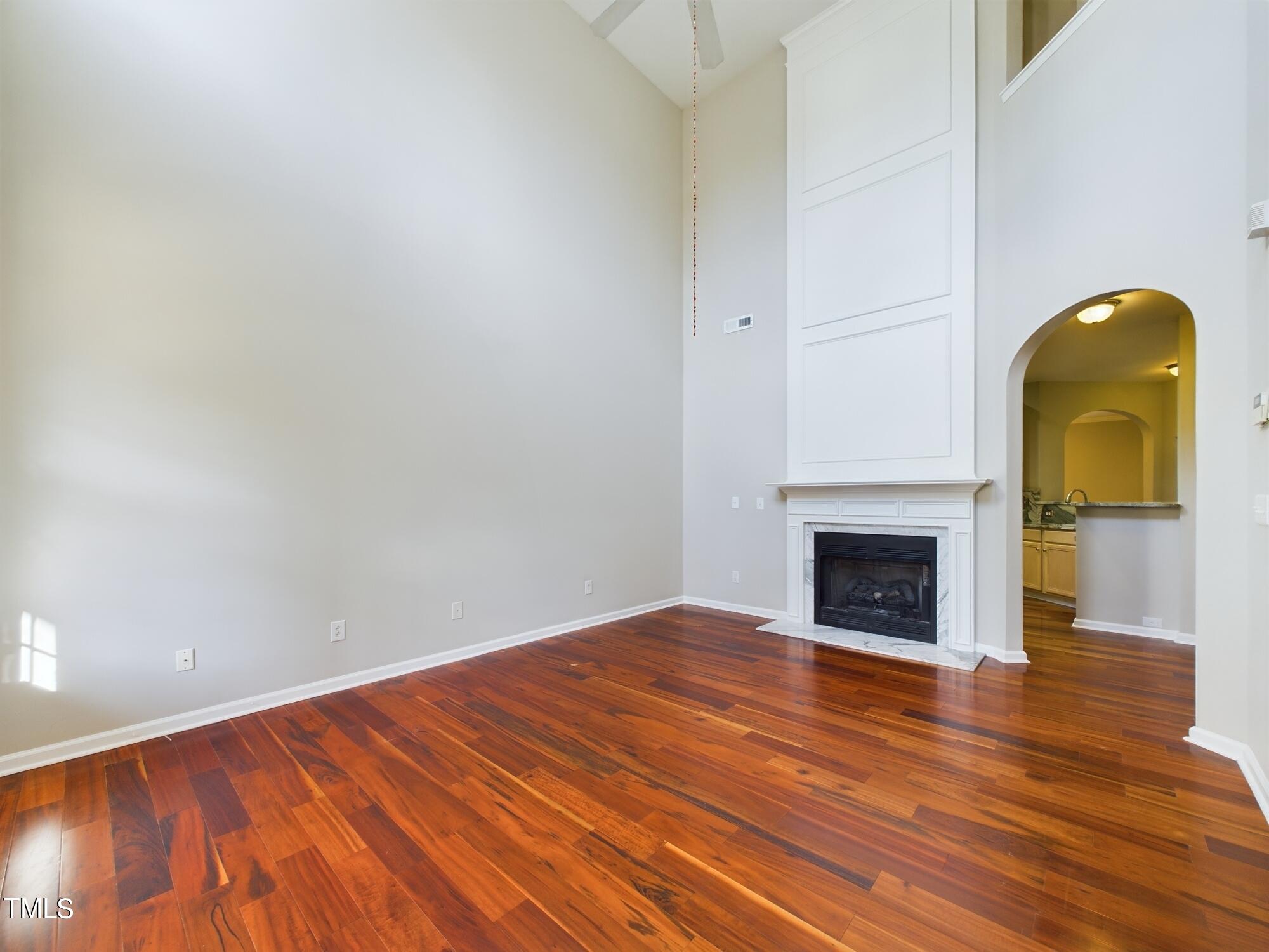 11124 Slider Drive Raleigh, NC 27614 - Photo 7 of 62 a view of empty room with wooden floor and fireplace