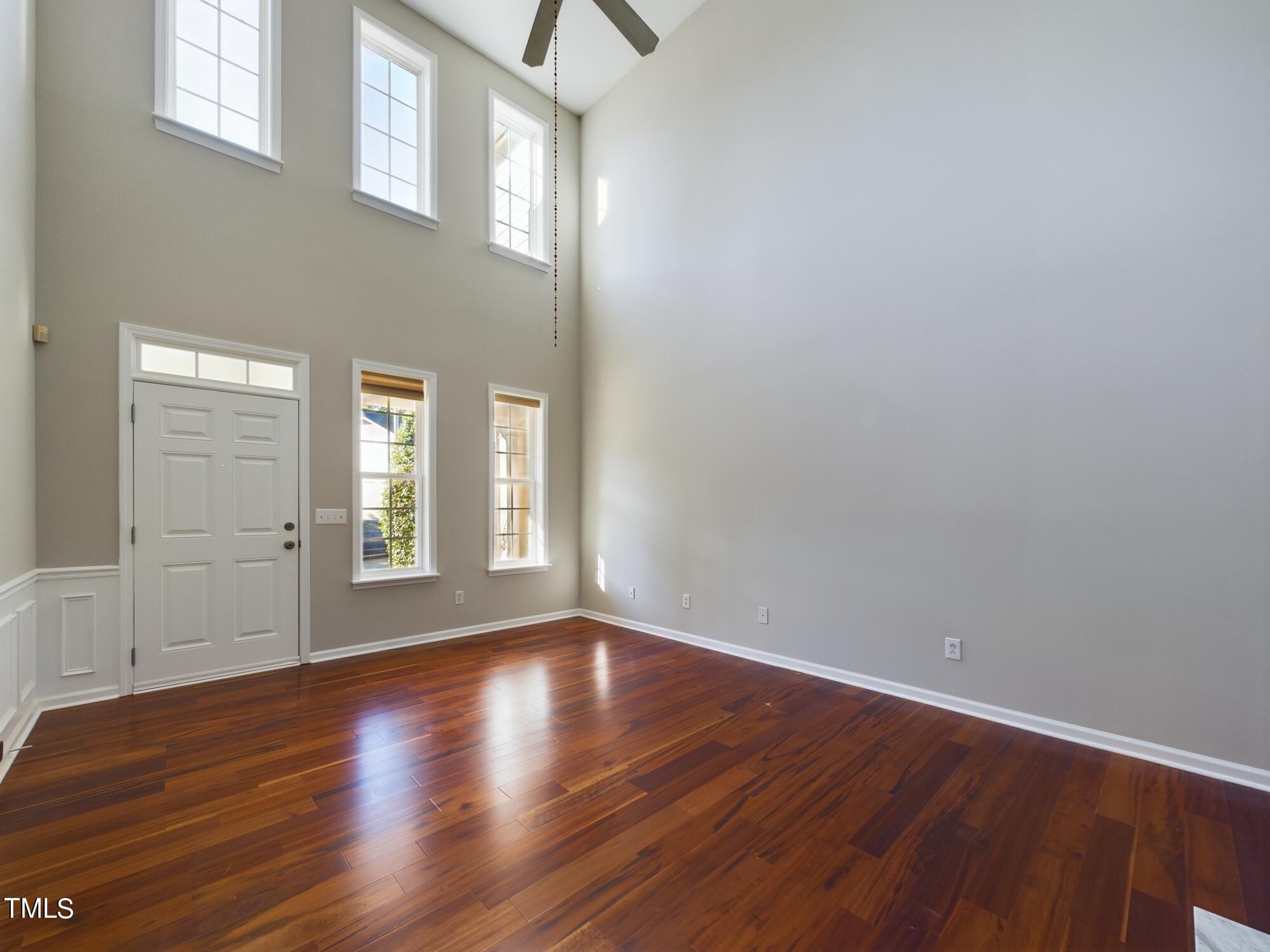 11124 Slider Drive Raleigh, NC 27614 - Photo 10 of 62 a view of an empty room with wooden floor and a window