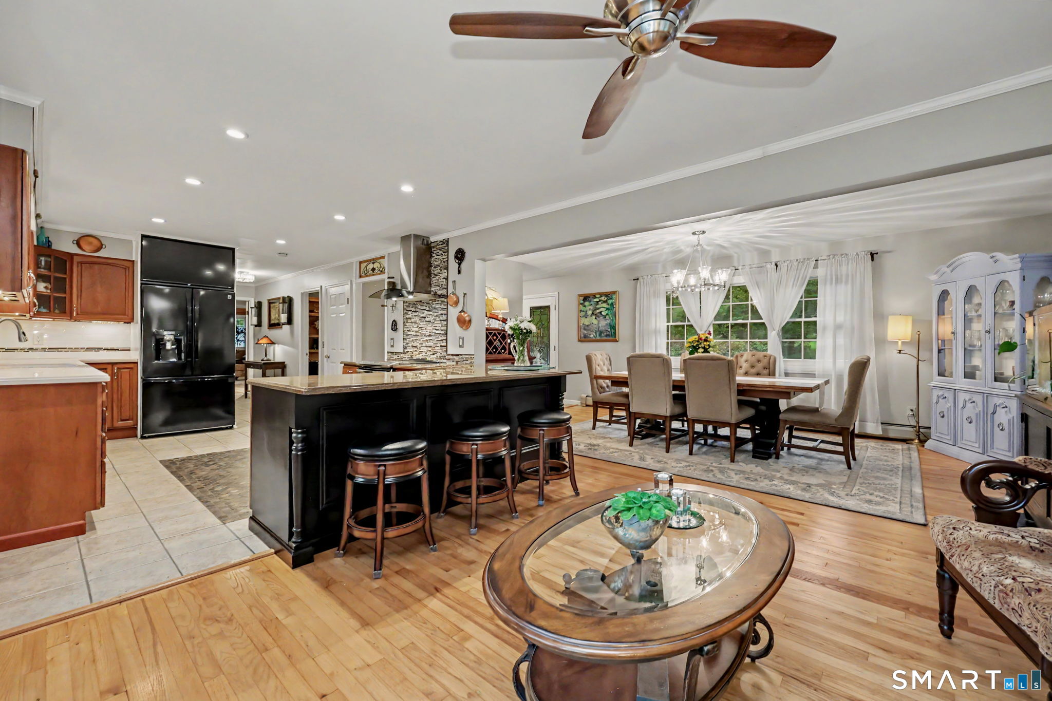 571 Wheeler Road Monroe, CT 06468 - Photo 7 of 40 a living room with furniture a dining table and a dining table with wooden floor