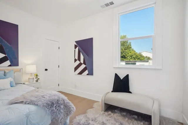 a bedroom with a bed and a couch