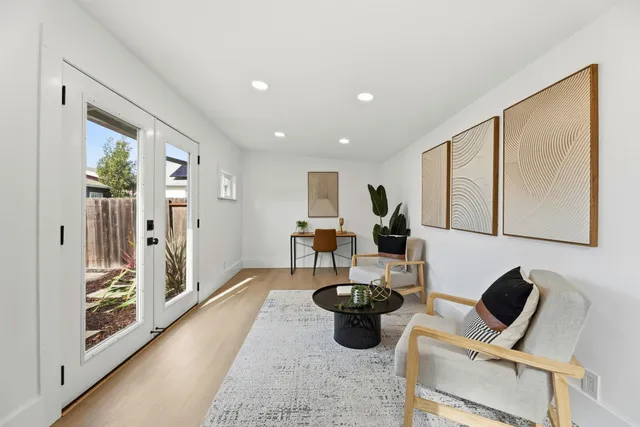 a living room with furniture a couch and large window