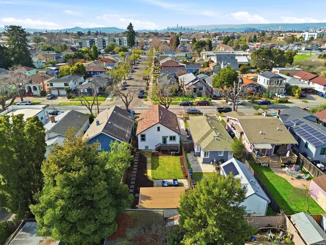 an aerial view of residential houses with outdoor space and swimming pool