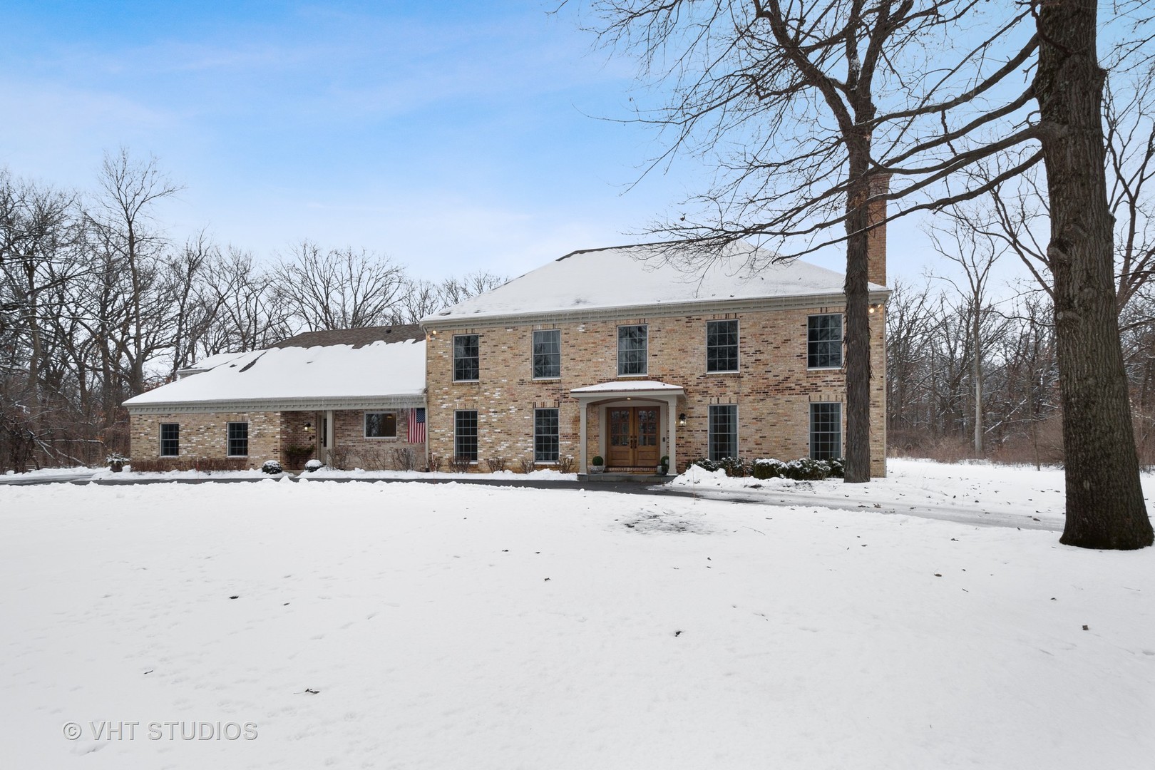 6814 Red Barn Road Crystal Lake, IL 60012 - Photo 1 of 50 a front view of a house with a yard covered in snow
