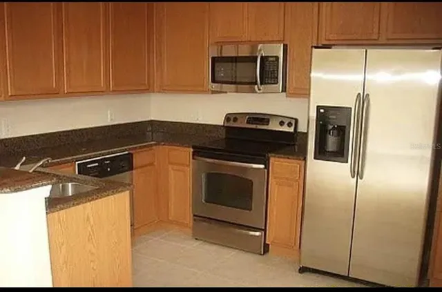 a kitchen with a sink and a stove top oven