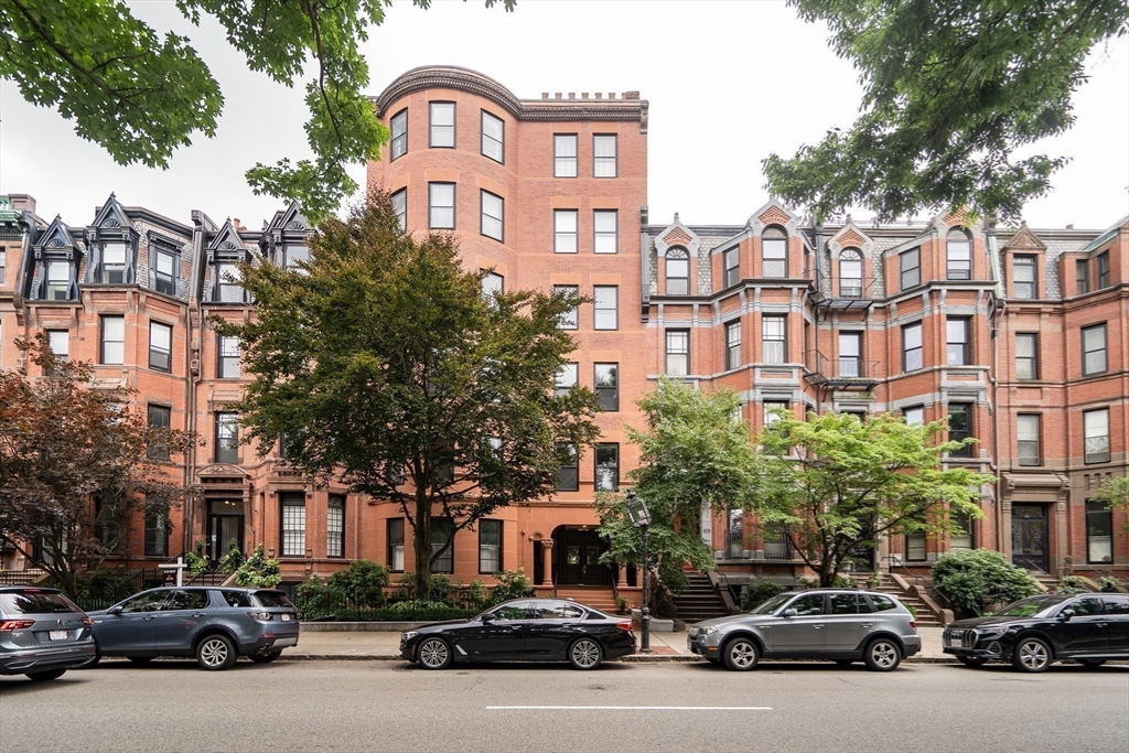 290 Commonwealth Avenue, Unit 8 Boston, MA 02115 - Photo 1 of 32 a city street lined with parked cars and buildings