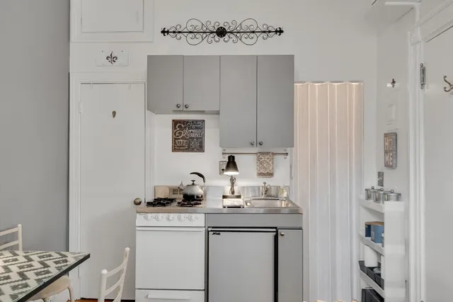 a kitchen with cabinets appliances and a sink