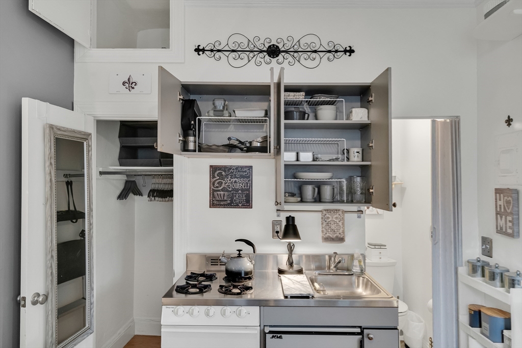 290 Commonwealth Avenue, Unit 8 Boston, MA 02115 - Photo 16 of 32 a kitchen with stainless steel appliances granite countertop a refrigerator and a stove top oven