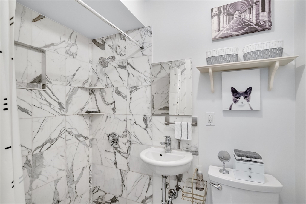 290 Commonwealth Avenue, Unit 8 Boston, MA 02115 - Photo 18 of 32 a bathroom with a sink and a mirror