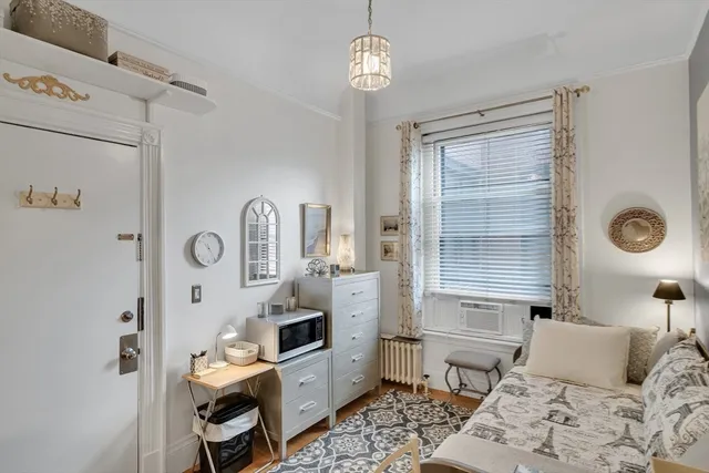 a bedroom with furniture and a window