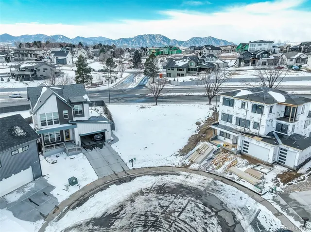 an aerial view of residential houses with city view