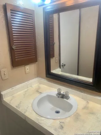 a bathroom with a sink and a mirror