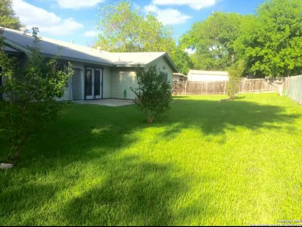 a view of a house with a backyard