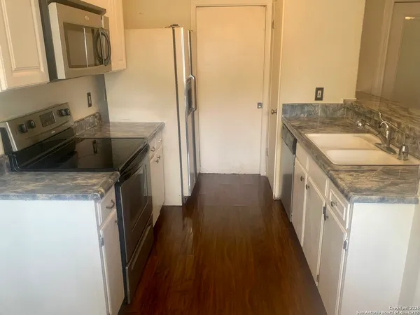 a kitchen with a sink stove and refrigerator